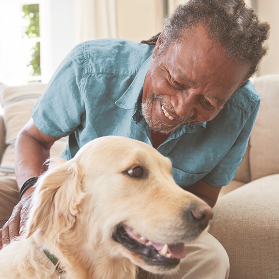 A person smiling with their dog