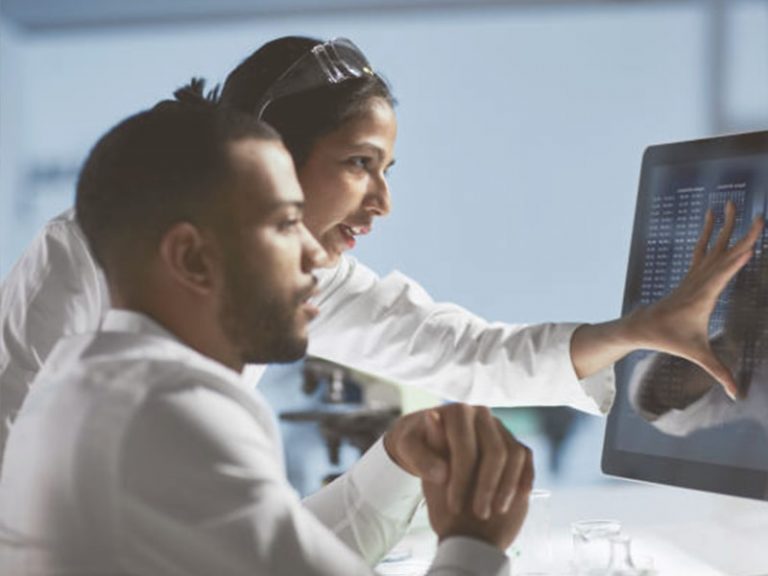 A physician and a patient at a computer