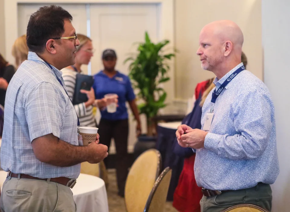 Primary Care Provider (PCP) Partner Program 2 Two healthcare professionals speaking during a professional networking event